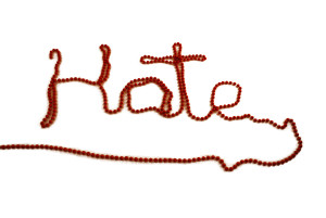 Hate written out in red beads